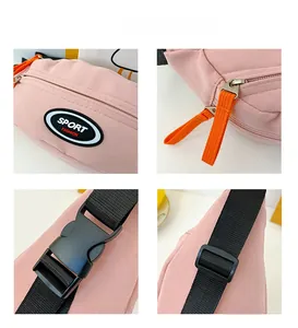 Detail view of pink crossbody bag with sport logo, zipper, buckle and adjustable strap