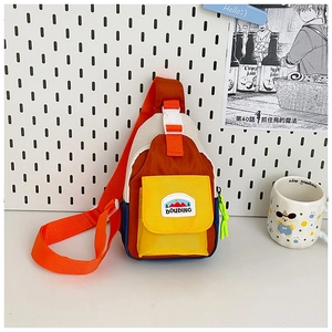 Detail of color-block kids chest bag with green zipper and durable nylon texture