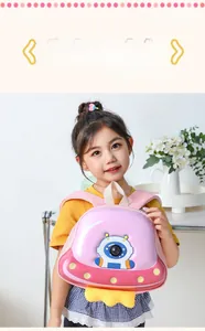 Detailed view of pink astronaut hardshell toddler backpack with 3D UFO design element
