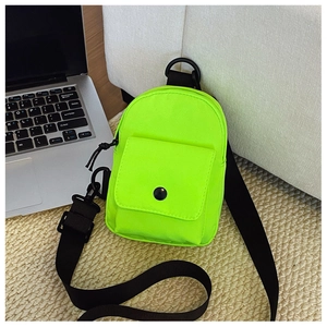 Detailed view of neon green mini crossbody bag with black buckle and nylon texture