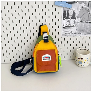 Detail of color-block kids crossbody bag with orange pocket and DOUDING logo patch