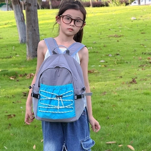 Spacious grey and blue kids outdoor backpack with drawstring detail for school and travel