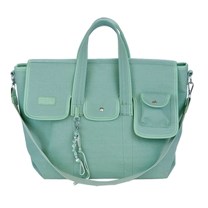 Mint green canvas crossbody bag with multiple front pockets and adjustable shoulder strap