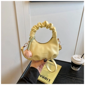 Detail of yellow ruched mini cloud bag for kids with flower charm and logo strap