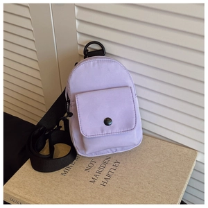 Detail of purple mini chest bag for kids with adjustable strap and front button pocket