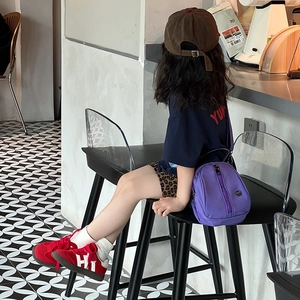 Kids casual purple shell crossbody bag paired with retro sports outfit and corduroy cap