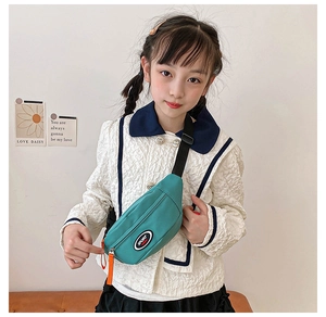 Detail of teal kids sport chest bag with orange zipper pull and adjustable black strap
