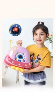 Close-up of pink UFO backpack featuring LED light-up eyes on 3D cartoon design