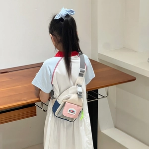 Kids color-block canvas chest bag with adjustable strap shown on child model