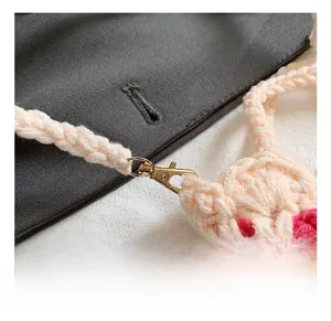 Detail of golden lobster clasp on handmade crochet tulip mini shoulder bag strap
