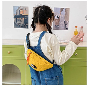 Detail of yellow nylon kids chest bag with SPORT patch and adjustable black strap buckle