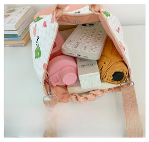 Detail view of large capacity canvas bag interior holding essentials with bear print