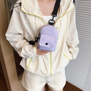 Mini lavender nylon chest bag with adjustable strap worn by a child in sporty attire