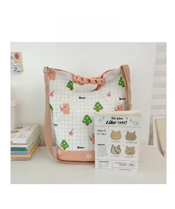 Detailed view of canvas kids crossbody bag with plaid pattern and cute cartoon bear print