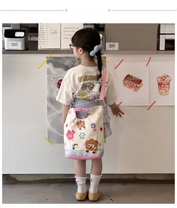 Detail showing high-quality canvas kids crossbody bag with cute bear prints and pink strap