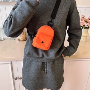 Kids vibrant orange nylon crossbody chest bag with adjustable black strap for outdoor casual use