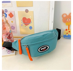 Detail of teal nylon kids fanny pack featuring sport fashion patch and orange zipper