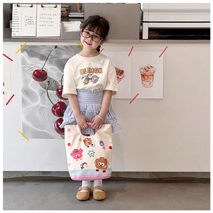 Detail of a white canvas tote bag for kids featuring colorful polka dots and cute cartoons