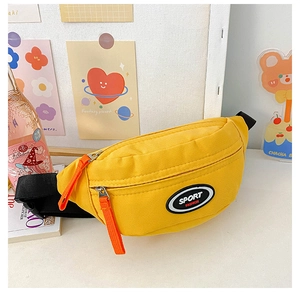 Detailed shot of yellow canvas chest bag featuring sport logo and orange zipper puller