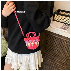 Detail of pink hand-knitted mini crossbody bag with 3D tulip flowers and pearl detail