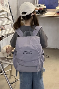 Close-up of lilac waterproof nylon kids backpack with XIXIHA logo and side drawstring pockets