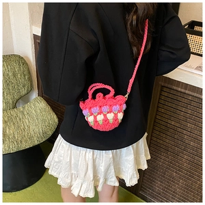Detailed close-up of handmade crochet tulip mini bag with vibrant floral knit patterns