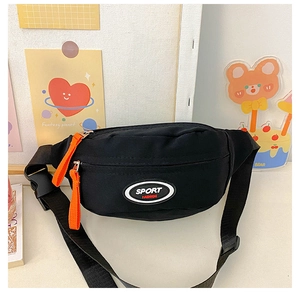 Detail view of black canvas kids chest bag with sport logo and bright orange zipper pullers