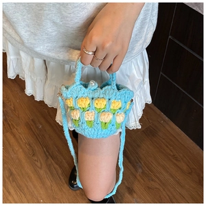 Detailed crochet texture of light blue tulip mini handbag with white pearl closure