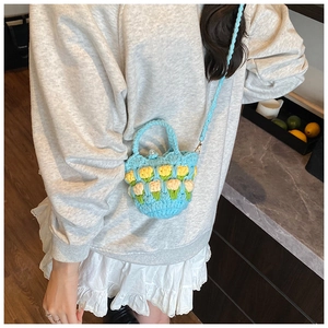 Detailed close-up of handmade crochet mini bag with 3D tulip floral knit patterns