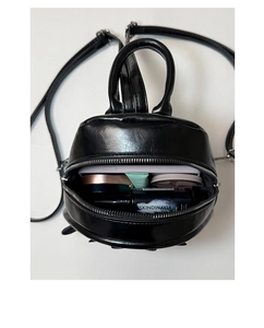 Internal view of mini black PU backpack showing capacity for phone and cosmetics