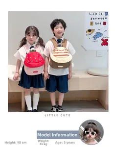 Detailed view of cute strawberry and mushroom toddler backpacks on little models