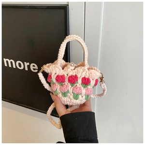Detail of crochet tulip bag showing woven flower patterns and pearl clasp closure