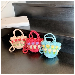 Detail of handmade crochet mini bags with 3D tulip patterns and pearl clasps