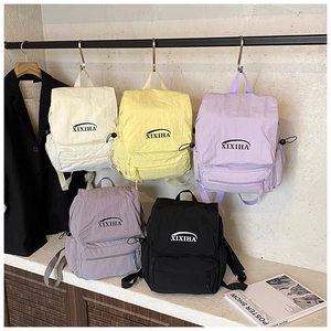 Detailed display of colorful nylon kids backpacks with adjustable straps and front zip pockets