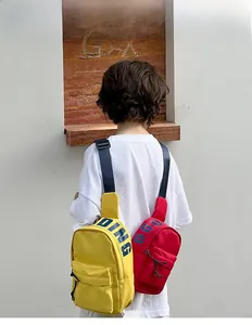 Outdoor shot showing vibrant yellow and red crossbody chest bags on a model