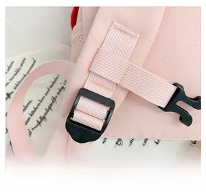 Detailed view of the adjustable pink shoulder strap with durable plastic buckle for kids