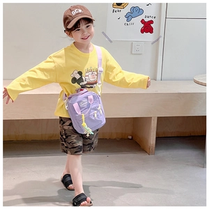 Detail of yellow toddler t-shirt with Mickey Mouse birthday print and purple crossbody bag