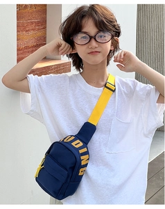 Detail of kids canvas crossbody bag in navy blue and yellow with JUDING print