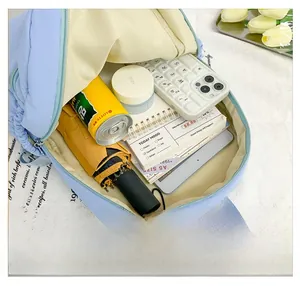 Macro detail of large capacity backpack interior showing various daily essentials