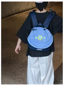 Detail of blue toddler space backpack with UFO design and durable nylon material texture