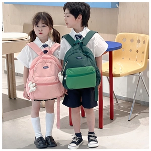 Detailed view of children's nylon backpacks with cute pendant and dual-color sporty design