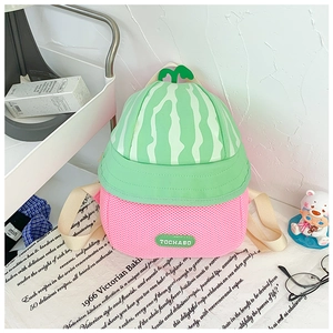 Detail view of watermelon-shaped toddler backpack with green stripes and mesh fabric