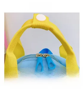 Detail of smooth blue zippers and yellow top handle on a cute cartoon airplane backpack