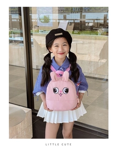 Close-up of pink toddler backpack with cute 3D bunny ears and cartoon face design
