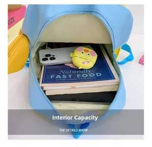 Detail view of the light blue backpack's spacious interior with books and accessories