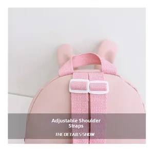 Close-up of adjustable pink straps and handle on a cute cartoon rabbit backpack