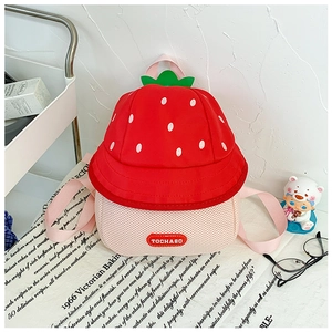 Detail view of the strawberry themed toddler backpack with green leaf and mesh pocket