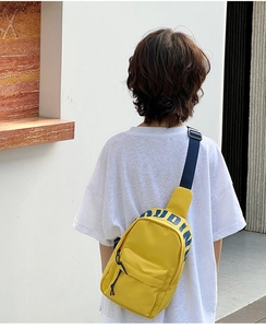 Detail of yellow nylon kids crossbody bag with blue lettering and adjustable strap
