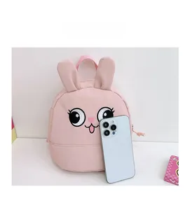 Detailed size comparison of pink rabbit kids backpack next to a smartphone