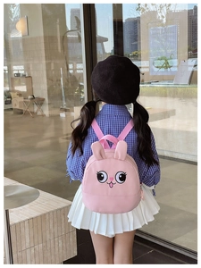 Toddler wearing cute pink bunny backpack with embroidery and adjustable straps